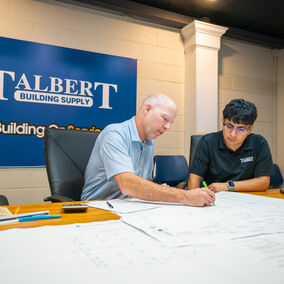 Talbert Building Supply employee reviewing building plans with a colleague at the Durham branch