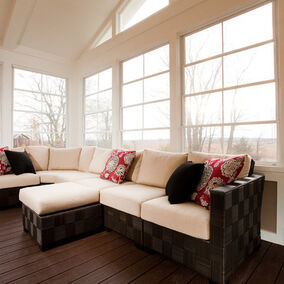 Sunroom with Eze-Breeze windows, featuring comfortable seating and ample natural light