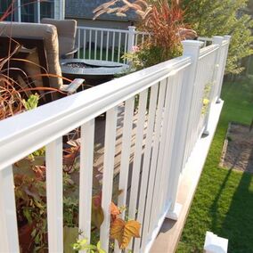 Deck featuring white Fortress railing, offering safety and style for outdoor living spaces