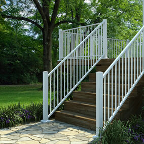 Outdoor patio stairs featuring white Fortress stair railing, providing safety and a clean aesthetic