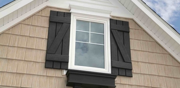 Home exterior with Fypon decorative brown shutters framing a window