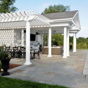 Outdoor patio featuring an HB&G pergola with classic white columns by a pool