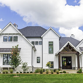 Modern home featuring LP SmartSide siding with white panels and a dark gray roof