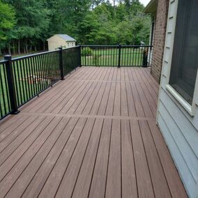 Fiberon composite decking with black AFCO aluminum railing, creating a durable and stylish outdoor living space