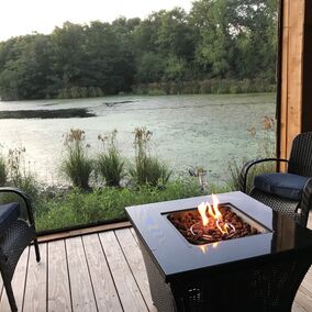 Freestanding porch with ScreenEze system, featuring a fire pit and lake view