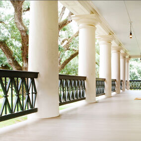 Oak Alley porch featuring Aeratis flooring and decorative railings, exemplifying premium craftsmanship and durability