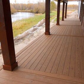 Green Bay Duxxbak Decking mineral-based composite decking on a rustic lakeside porch