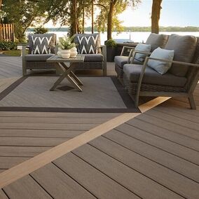 Lakefront deck featuring TimberTech decking with stylish outdoor furniture