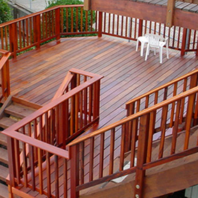 Multi-level outdoor deck made with durable TigerDeck hardwood, featuring natural wood tones and custom railing