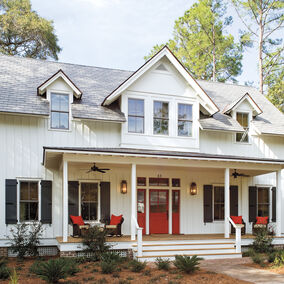 Front view of a home with Windsor Legend HBR windows and a large porch